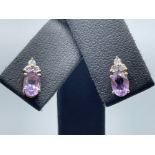 Ladies 9ct gold Purple stone Diamond stud earrings.