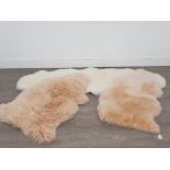 Two pink sheepskin rugs by Cox & Cox, and another sheepskin rug by Phoenox 160cm long.