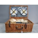 An Antler picnic set with original contents to include plates mugs and cutlery