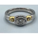 Ladies Platinum and 18ct gold Diamond ring. Comprising of a Round brilliant cut diamond set in a rub