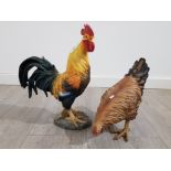 Resin figurines of a cockerel and hen, cockerel measures 45.5cm high.