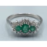 Ladies 9ct white gold Emerald and diamond cluster ring. Featuring 3 Emerald stones set and