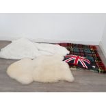 An Axminster sheepskin rug 100cm wide, a tartan wool rug, sheepskin effect throw and a union jack