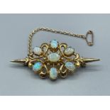 Ladies 9ct gold Opal cluster brooch. Featuring a oval shaped opal in centre surrounded by 6 oval