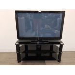 A Panasonic Viera 40in flat screen TV with remote and stand.