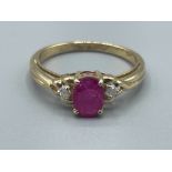 Ladies 9ct gold Ruby and diamond ring. Featuring a oval Ruby stone set with a round brilliant cut