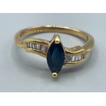 Ladies 18ct gold Sapphire and Diamond ring. Featuring blue marquise shape sapphire and surrounded by