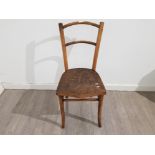 A bentwood chair with decoration to seat.