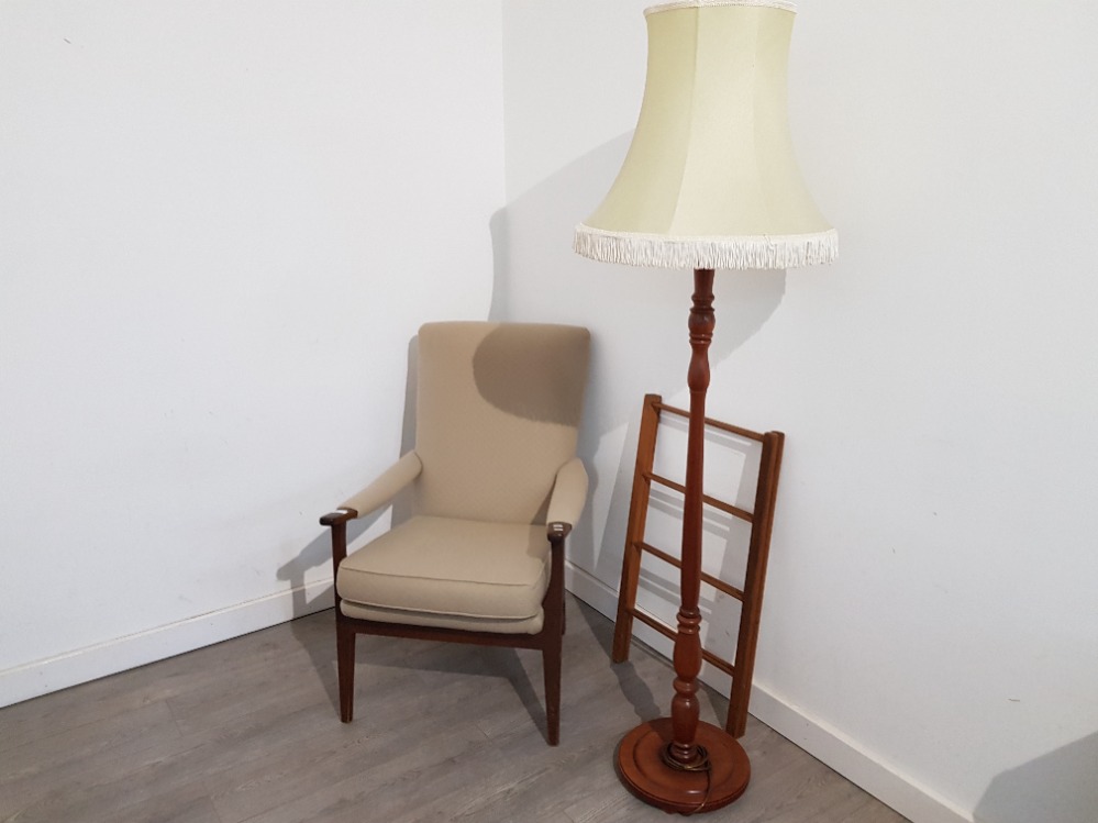 A stained beech open armchair, standard lamp with cream shade, and a towel airer.