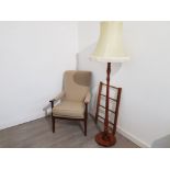 A stained beech open armchair, standard lamp with cream shade, and a towel airer.