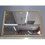 A modern bevelled wall mirror in gold frame 67 x 95cm.