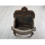 A Victorian cast iron fire grate