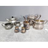 A three piece silver plated tea set, a pewter tea set, and a pair of plated egg cups by Mappin and