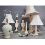 A quantity of table lamps to include a pair of alabaster column lamps, together with shades.