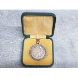 The Royal life saving society award of merit medal, hallmarked Birmingham silver 1931 and awarded to