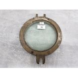 A brass porthole, made in liverpool, with military arrow 19.5cm diameter.