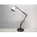 A 1940s black painted metal anglepoise lamp, 85cm high approx, pat tested.