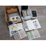 2 boxes of uncirculated stamps from around the world some in albums, also includes religious themed