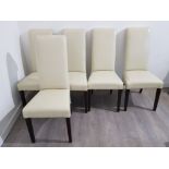 Five cream leather effect dining chairs with slender backs.