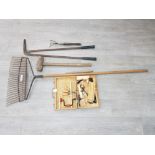 An Elwell lawn comb, sledgehammer and other tools.