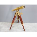 Modern minature brass telescope on wooden tripod stand