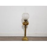 A Victorian brass oil lamp with glass shade, supported on corinthian column 53cm high excluding