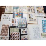Quantity of mixed stamps, albums and full sheets of uncirculated stamps