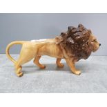 A Beswisk male lion figurine 25cm long (good condition).