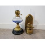 A victorian brass oil lamp together with a brass wall mounted oil lamp.