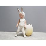 A Gebruder Heubach bisque easter bunny figure with moveable arms, 15.5cm high.