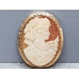 A carved cameo brooch of a lady on 9ct gold mount 6cm high.