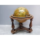 A small wooden globe on stand 20cm high.