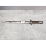 A Victorian bayonet with wooden grip.