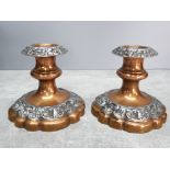 A pair of copper and pewter candlesticks 10cm high.