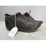 A pair of late 19th/20th century leather children's shoes with wooden soles 19.5cm long.