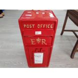 A red painted metal royal mail post box