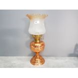 A copper oil lamp with glass shade 44.5cm high.