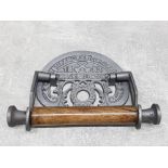 A reproduction cast metal St Pancras toilet roll holder.