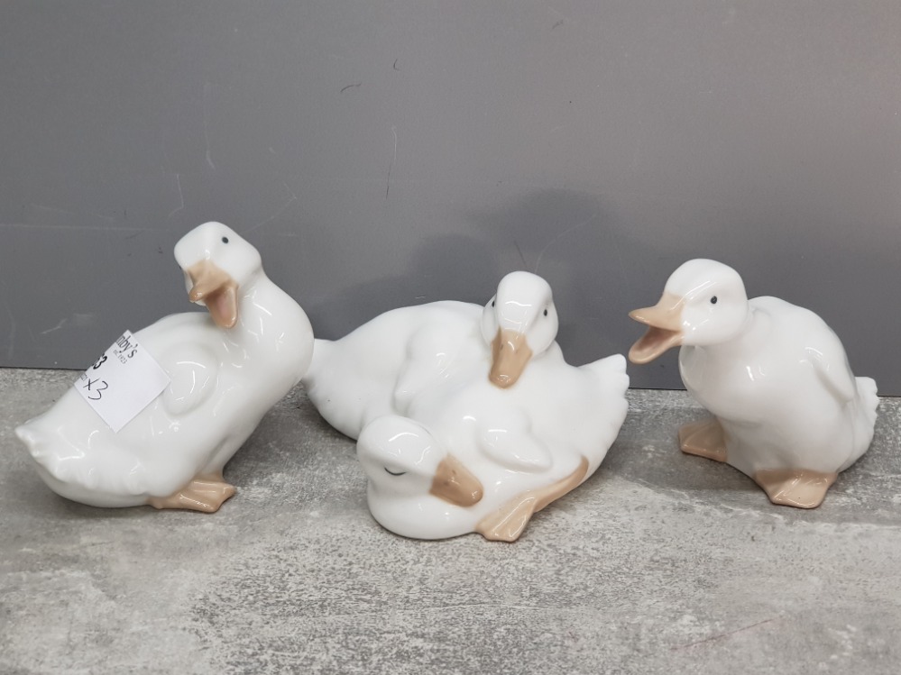 Three Nao white duck figurines and group.