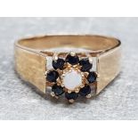 Ladies 9ct yellow gold sapphire and opal cluster ring, featuring a round opal set in the centre