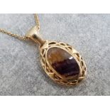 Ladies 9ct yellow gold stone set pendant and chain featuring purple/yellow oval shaped stone set