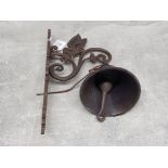 A reproduction cast metal outside wall hanging bell with butterfly decoration.