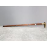 A brass and wooden walking stick.