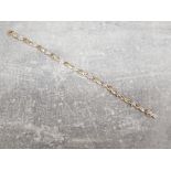 Ladies 9ct yellow gold diamond cluster bracelet, festuring 10 Baguette diamond rub over set