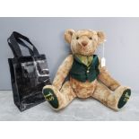 A Harrods jointed teddy bear, 52cm high, and a bag.