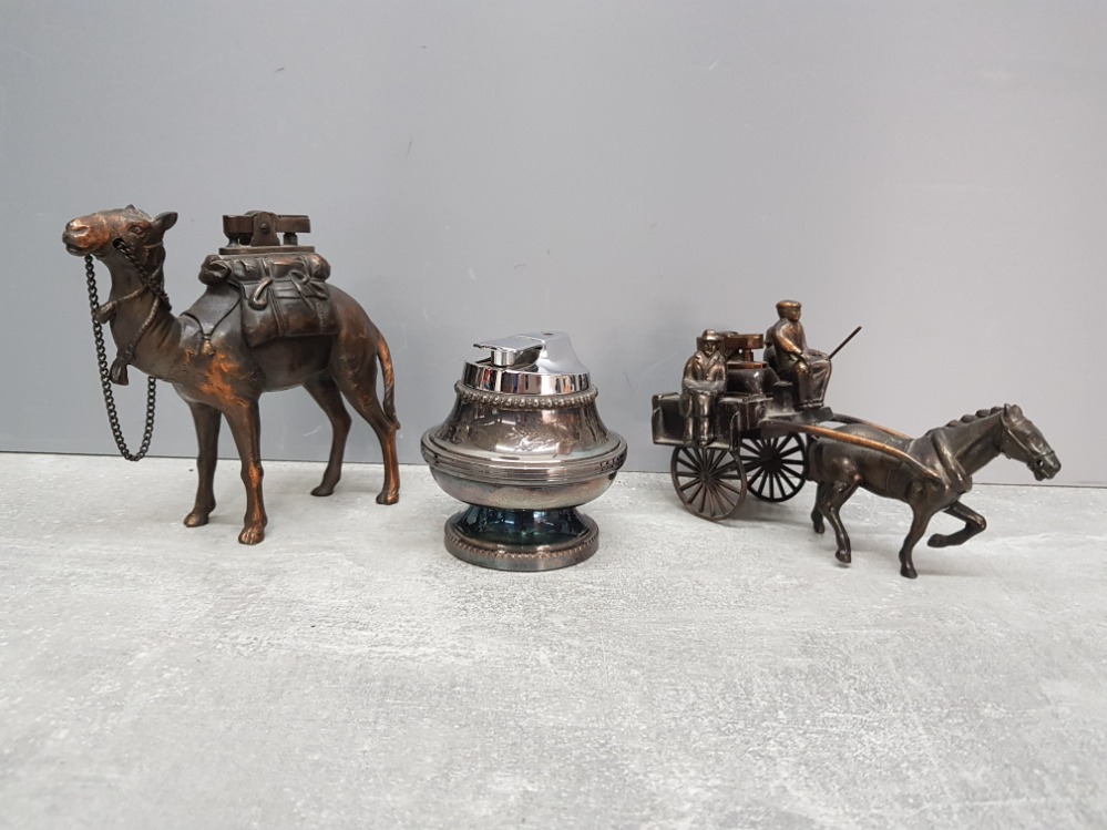 Three table lighters to include a camel and horse and carriage.