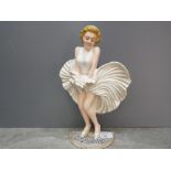 A cast iron door stop in the form of Marilyn Monroe.