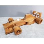 A wooden model of a F1 racing car 45cm long.
