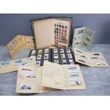 A stamp album together with cigarette carss by John Player and Will's.