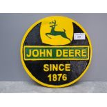 A reproduction John Deere cast iron circular plaque.